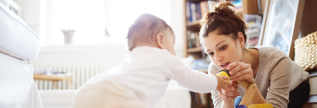 Parents can trust this young woman babysitter playing on the floor with a crawling infant.