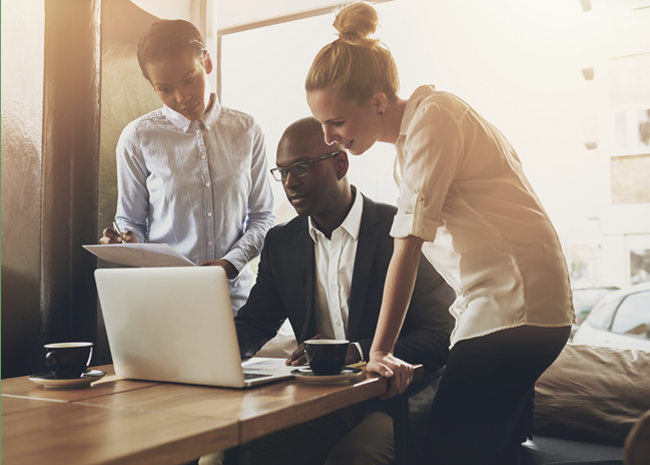 Professional business man working with two new hires that were thoroughly vetted.