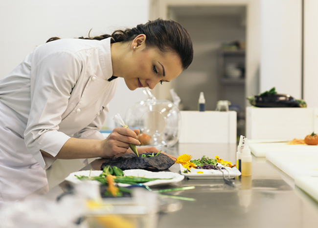 Private in-home female chef preparing a meal